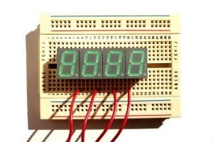 A breadboard with 7 segment displays attached