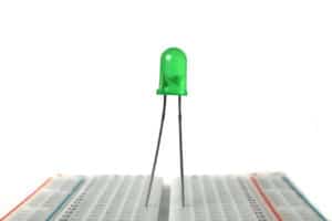 A green light emitting diode on a breadboard