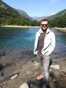 Me standing by a river with a weak current in the Norwegian mountains